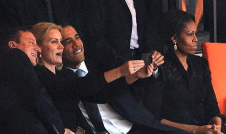 Image A: a group of people posing for a selfie at a public event.